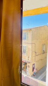 a view of a building from a train window at CHEZ FIFI - studio 28m2 - hyper centre - wifi in Cassis