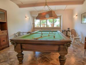 a pool table in a living room with at Villa Poggio Patrignone-1 by Interhome in Campoluci