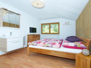 a bedroom with a bed and a sink at Holiday Home Runnimoos-1 by Interhome in Innerlaterns