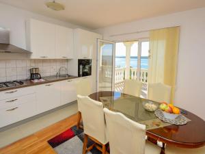 a kitchen and dining room with a table and chairs at Holiday Home Ana by Interhome in Maslenica