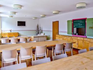 A television and/or entertainment centre at Holiday Home Runnimoos-3 by Interhome