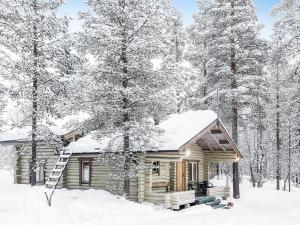 a log cabin in the snow with trees at Holiday Home Saivontupa by Interhome in Ylikyro