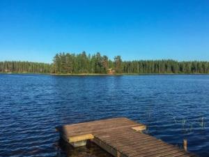 a dock in the middle of a large lake at Holiday Home Riihiranta by Interhome in Petäjävesi +19 photos