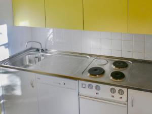 a kitchen with a sink and a stove top oven at Apartment Mont-Soleil-2 by Interhome in Nendaz