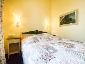 a hotel room with a bed with a quilt on it at Landhotel Schloss Daschow in Daschow