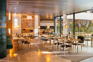 a restaurant with tables and chairs in a room at Ocean Drive Madrid in Madrid