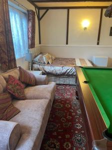 a living room with a couch and a pool table at Jasmine House in Newquay