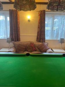 a green pool table in a living room with a couch at Jasmine House in Newquay