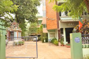 a building with a gate in the middle of a street at VALLI HOTEL in Thanjāvūr