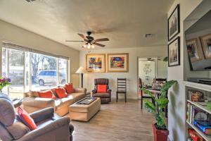 a living room with couches and a ceiling fan at Pet-Friendly Phoenix Home with Breezeway and Fire Pit! in Phoenix