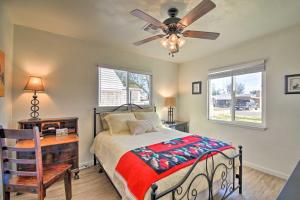a bedroom with a bed with a ceiling fan and a desk at Pet-Friendly Phoenix Home Breezeway and Fenced Yard in Phoenix +19 photos