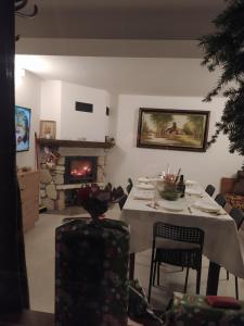a living room with a table and a fireplace at Casa Del Grey in Balchik
