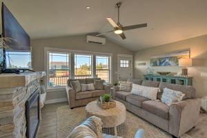 a living room with a couch and a tv at Pet-Friendly Retreat with Game Room - Walk to Beach! in Ocean Shores