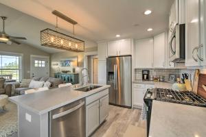 a kitchen with white cabinets and stainless steel appliances at Pet-Friendly Retreat with Game Room - Walk to Beach! in Ocean Shores