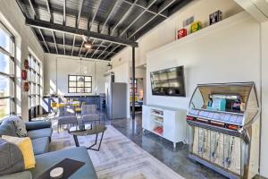 a living room with a flat screen tv on a wall at Unique Texas Home in Converted Gas Station! in Schulenburg