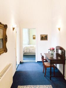 Landhotel Schloss Daschow في Daschow: غرفة مع طاولة وغرفة نوم مع سرير