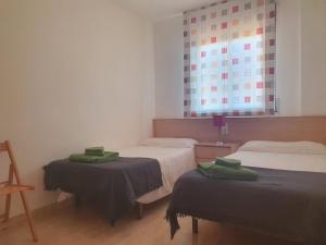 Postel nebo postele na pokoji v ubytování Apartaments Flamingo