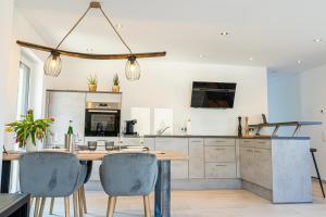 a kitchen with a wooden table and chairs at Weinrebe in Bernkastel-Kues