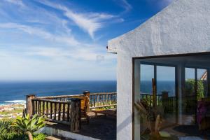a balcony of a house with a view of the ocean at Casa da Pedreira in Mosteiros