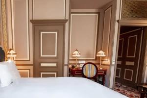 a bedroom with a white bed and two lamps at InterContinental Bordeaux Le Grand Hotel, an IHG Hotel in Bordeaux