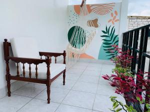 a porch with a bench and a hammock at Hotel Oro Blanco in Atacames