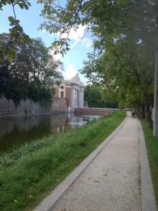 un chemin en face d'un bâtiment à côté d'une rivière dans l'établissement Guesthouse Villa Vauban, à Ypres