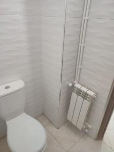 a white bathroom with a toilet and a shower at The good stay 1midelt in Midelt