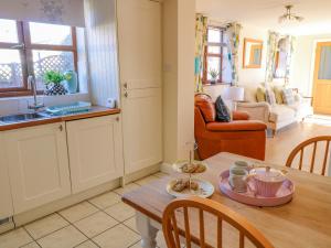 a kitchen and living room with a table and a sink at The Stable in Lincoln