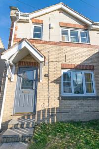 a house with a white door with a sign on it at Windy House in Sheffield