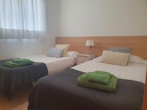Postel nebo postele na pokoji v ubytování Apartaments Flamingo