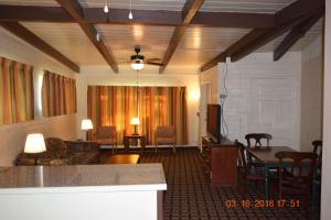 a living room with a couch and a table and a dining room at Stanlunds Inn and Suites in Borrego Springs