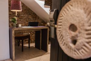 a wooden door with a desk and a table with a laptop at HC6 Boutique Marbella - Adults Only in Marbella
