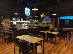 a restaurant with tables and chairs and a bar at HI Serra da Estrela - Pousada de Juventude in Penhas da Saúde