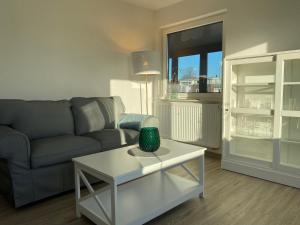 a living room with a couch and a table at Haus Pirola Esens in Esens