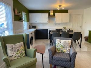 a kitchen with two chairs and a table in it at No2 at Rosebank Apartments in Moville
