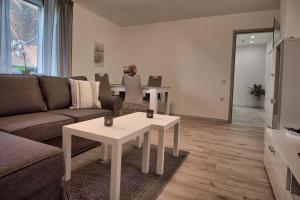 ein Wohnzimmer mit einem Sofa und einem Tisch in der Unterkunft Maisonette privater Zugang Waschmaschine Parkplatz in Hagen