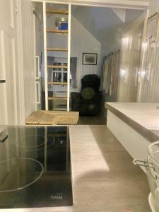 a kitchen with a glass counter top in a room at Olenilsøya Mini Villa in Reine