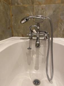 a bath tub with a sink with a faucet at The Seven Stars in Timsbury