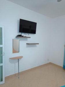 TV a/nebo společenská místnost v ubytování Residencia Jacarandas