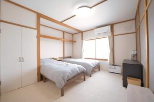 Ένα ή περισσότερα κρεβάτια σε δωμάτιο στο Furano Ski House - Vacation STAY 22794v