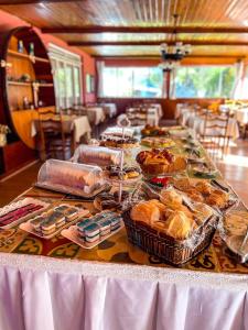 a table with a buffet of food on it at Hotel Ascona in Campos do Jordão