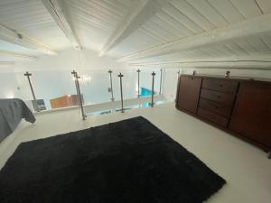 a large room with a black rug on the floor at Marisa’s House in Cefalù