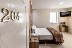 Tempat tidur dalam kamar di Hotel Solec Piura