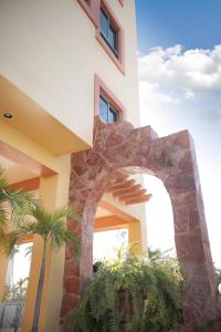 a building with a stone archway in front of it at Hotel Conquistador in Mazatlán