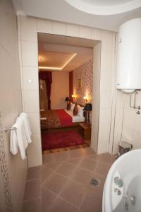 a hotel room with a bed and a bathroom at Hotel RAS Pazarište in Novi Pazar