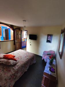 a hotel room with two beds and a tv at Quinta da Bela Vista in Caeté +33 photos