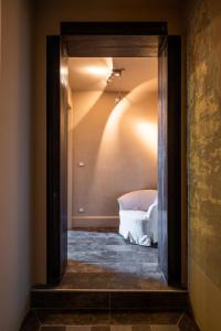 a doorway into a room with a bed in it at La Didì Maison in Bologna