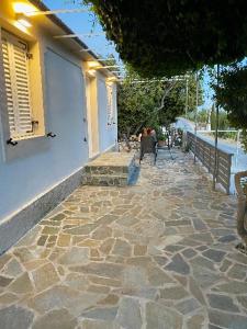 a stone walkway in front of a house with a building at Dina’s house 2 in Argostoli