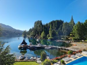 a marina on a river with boats in the water at Manzano Resort in Villa La Angostura