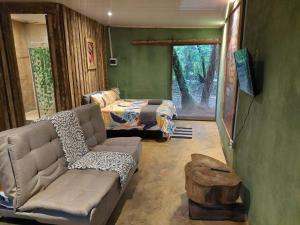 a living room with a couch and a bed at Vulture's View 7 in Pretoria